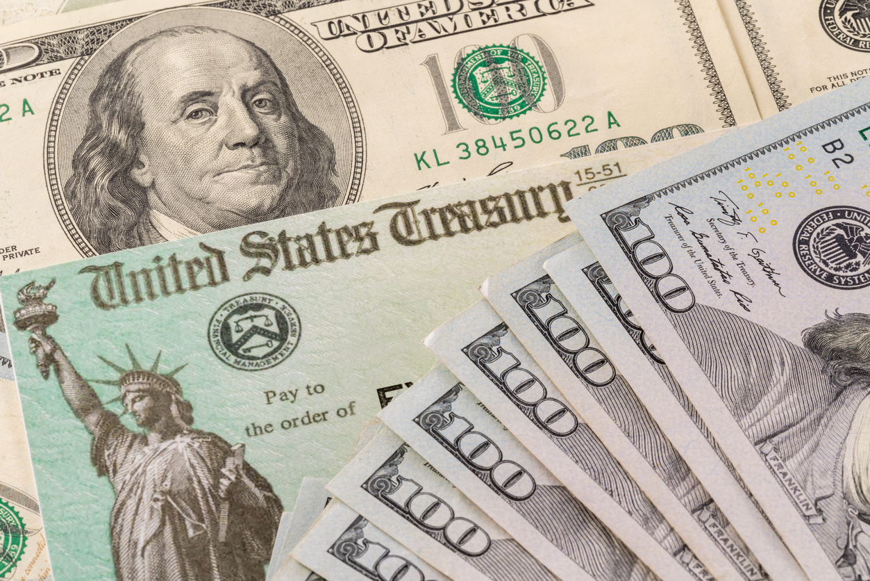 Treasury Checks and Hundred Dollar Bills Image